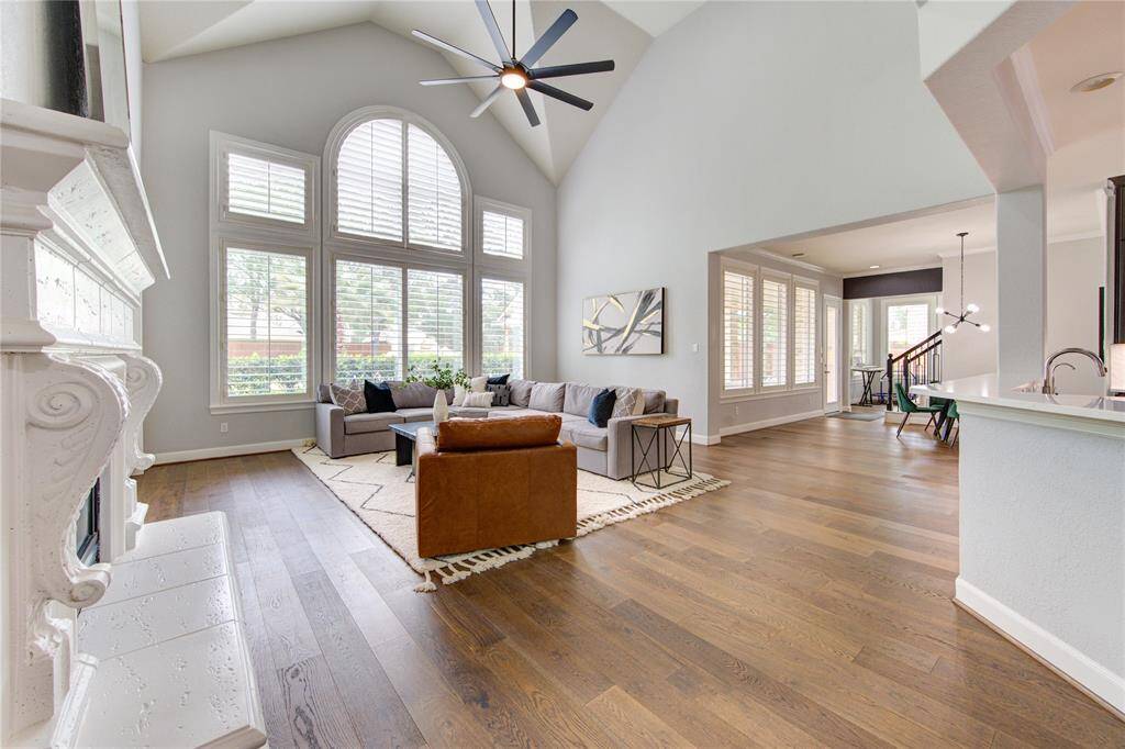 Spacious and elegantly designed living room with soaring ceilings, abundant natural light and seamless flow into the heart of the home