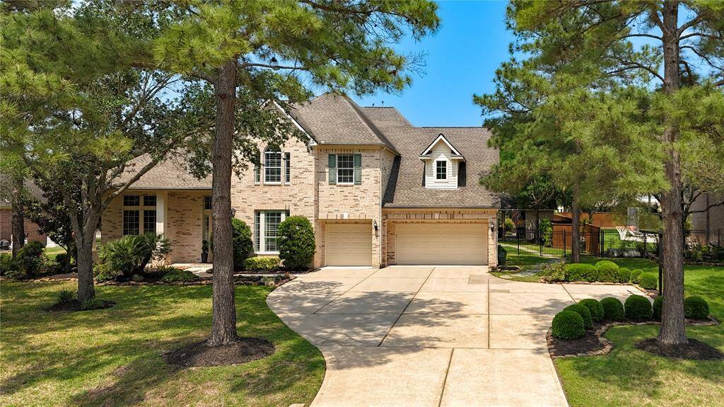 A wide driveway and well-manicured front lawn add to the inviting presence of this beautifully maintained residence