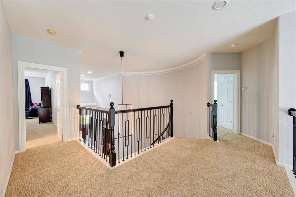 Flexible open landing area offers access to secondary bedrooms and entertainment spaces with stylish continuity throughout