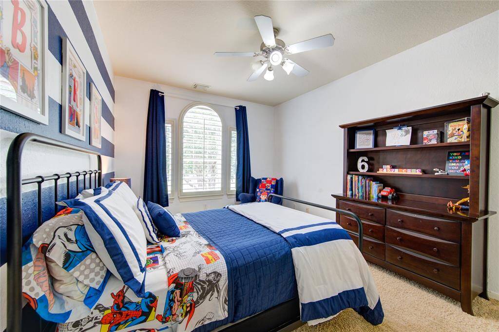Charming secondary bedroom with large window and ensuite access for ultimate privacy