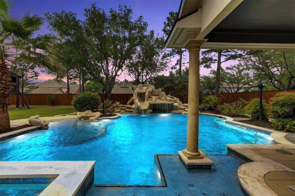 A serene twilight escape featuring a sparkling pool and lush landscaping—perfect for entertaining or unwinding under the stars