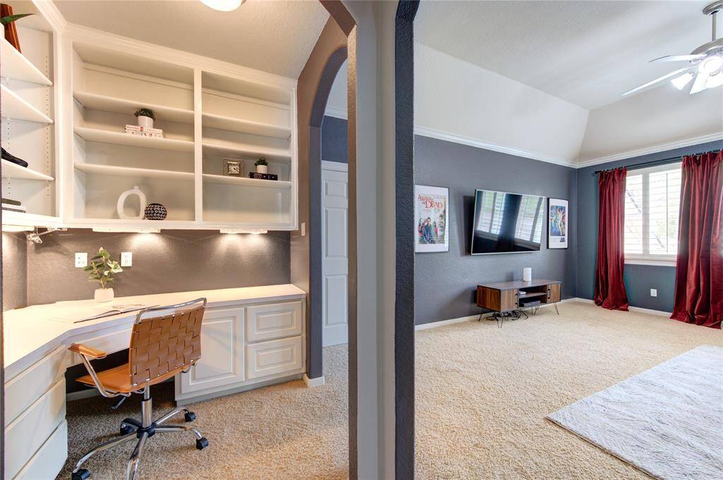 Dedicated study space with built-in shelving and natural light, tucked off the game room for focus and productivity