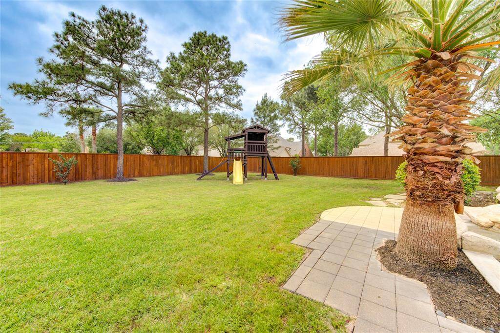 Fun meets function with a dedicated play area nestled within the backyard oasis