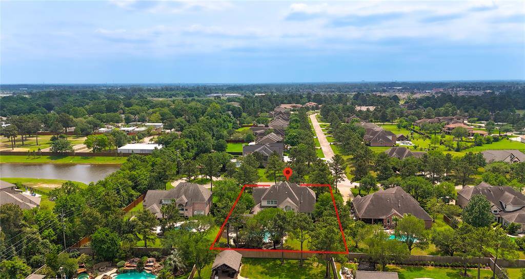 Bird’s-eye view of the beautifully maintained community, showcasing tree-lined streets and premium location