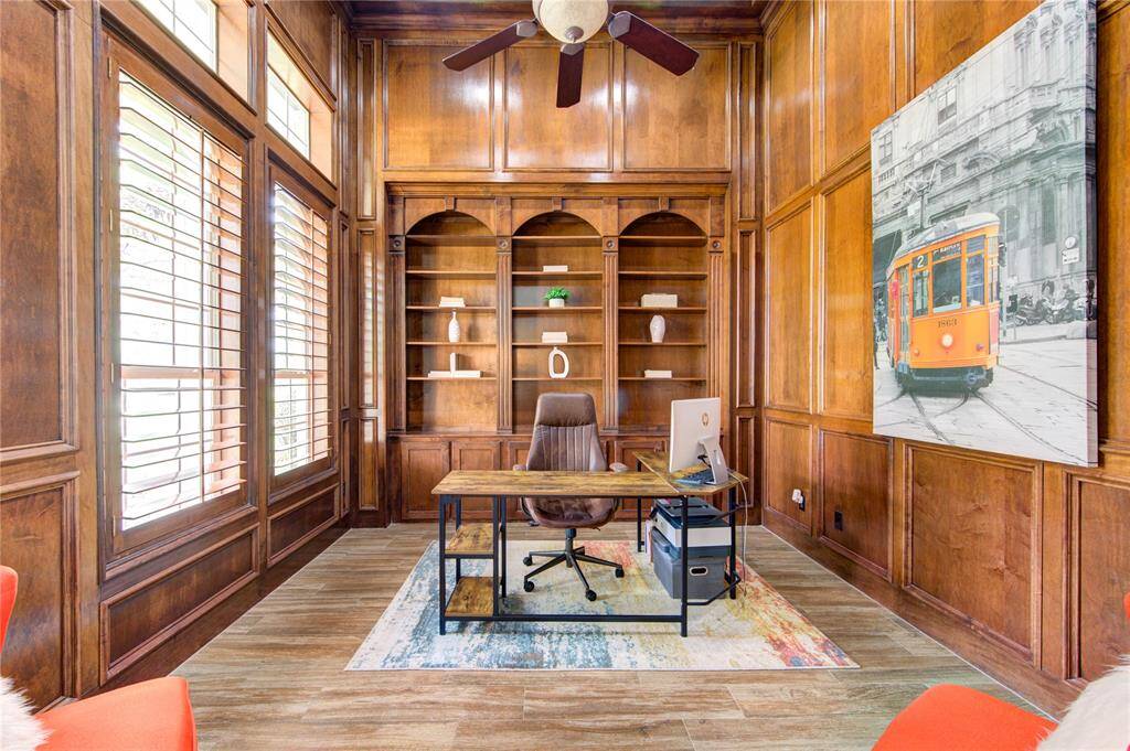 The executive-style study features custom wood paneling and serene natural light—perfect for working from home in style