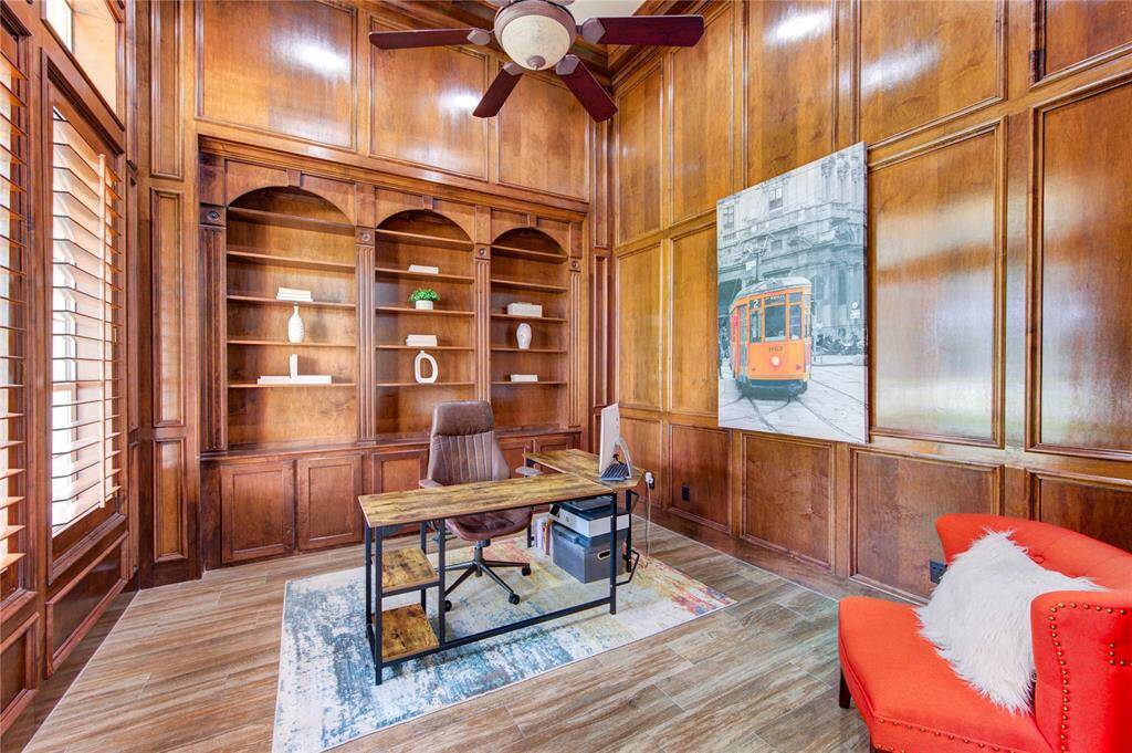 Natural light fills the room accentuating the craftsmanship of the built-ins and warm, rich tones for a serene working environment
