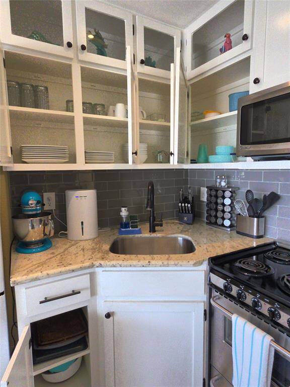 Fully stocked kitchen with dishes, storage containers, glass and plastic beverage containers, mixing bowls, bakeware and more all of which conveys with unit.