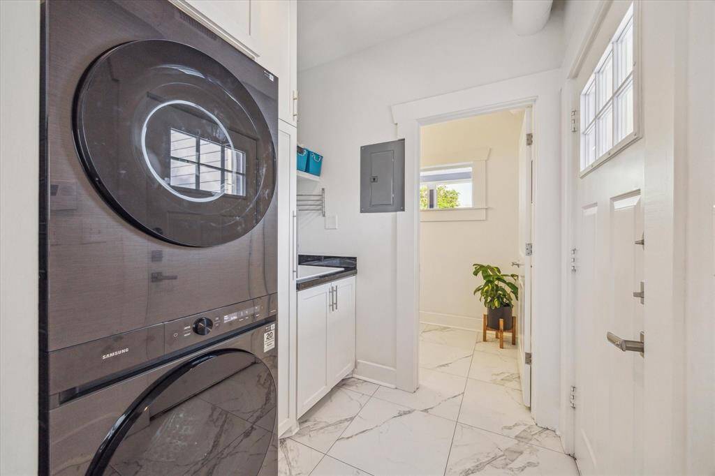 The laundry/mud room adjoins the family room and is where you would enter from the rear of the home and features it's own sink. The half bath is just beyond to the right of the back door when entering.