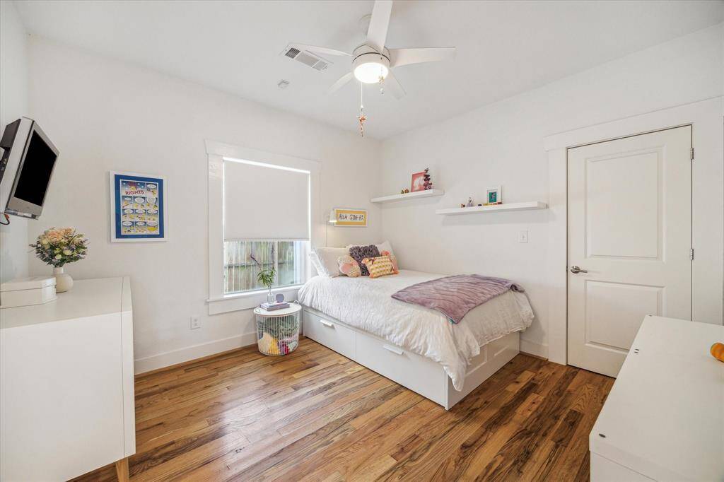 Guest bedroom 1. You can see there are hardwood floors throughout the home. No carpet here!