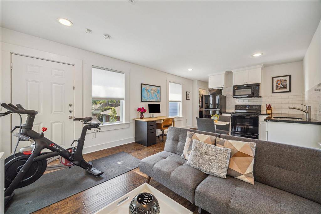 The extra room has been utilized as an office and an excercise space. It is part of the mother-in-law suite and features a full kitchen.