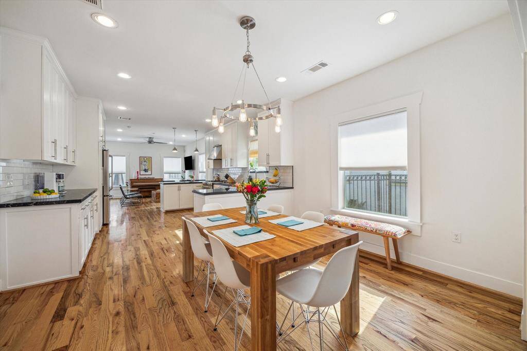 The dining area transitions seemlessly into the kitchen area. Coffee bar seen to the left.
