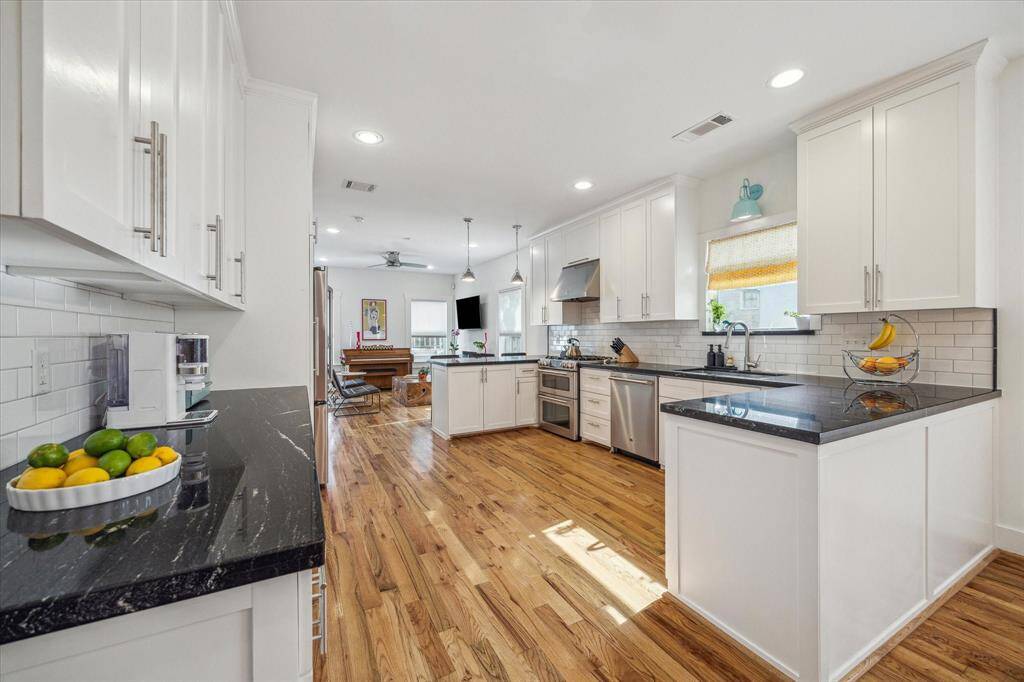The kitchen holds a timeless aesthetic. Subway tiles and shaker style cabinets meet black granite countertops.