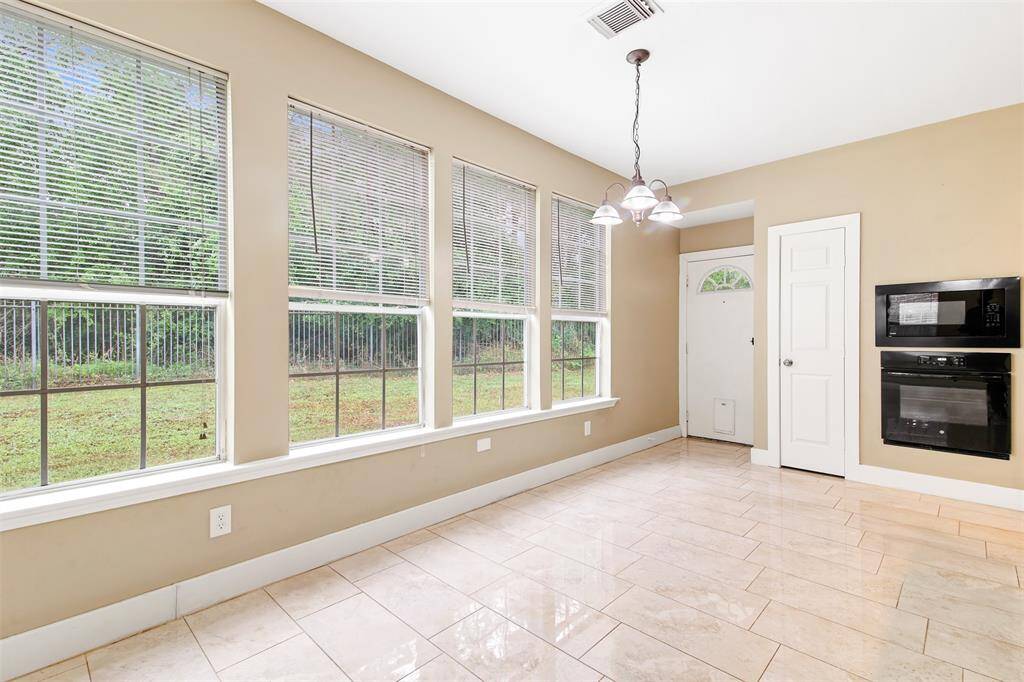 Breakfast room has tile floors and lots of windows.