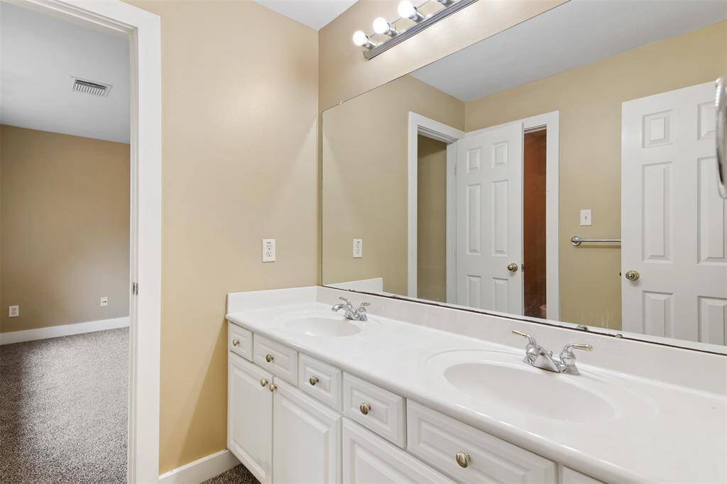 Secondary full bathroom upstairs has double sinks and tub/shower combo.
