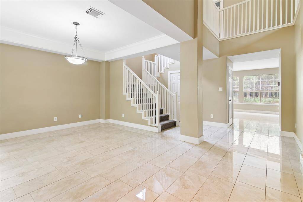 Two story front entry of home opens to the dining room.