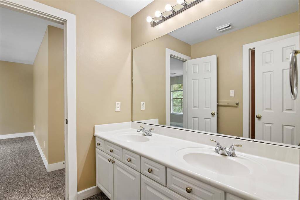 Another full bathroom upstairs with double sinks.