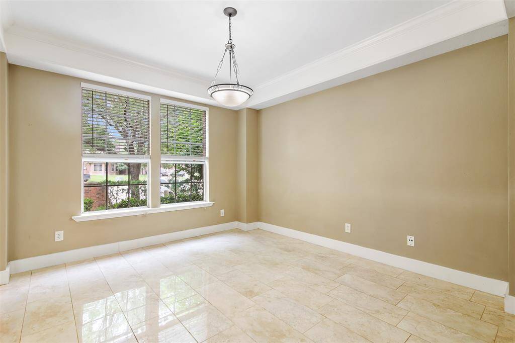 The dining room features tile floors, tray ceiling and large picture windows.