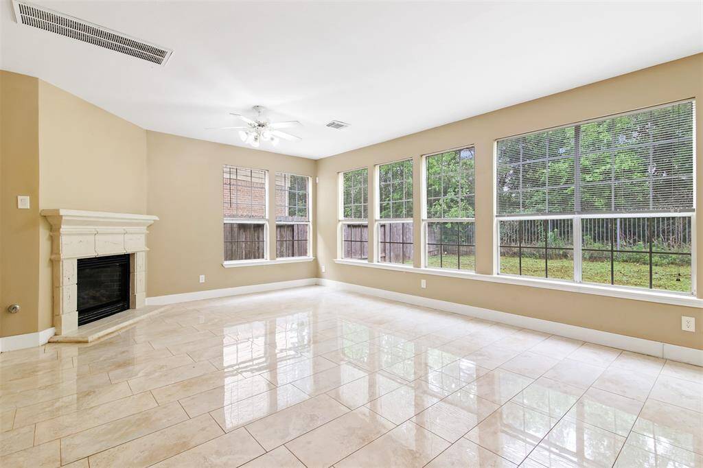 Family room has wall of windows looking out into the wooded back for plenty of natural light.
