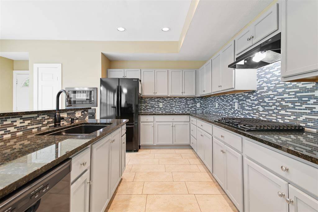The kitchen has canned lighting, gas cooktop, under-mount sink and plenty of storage.