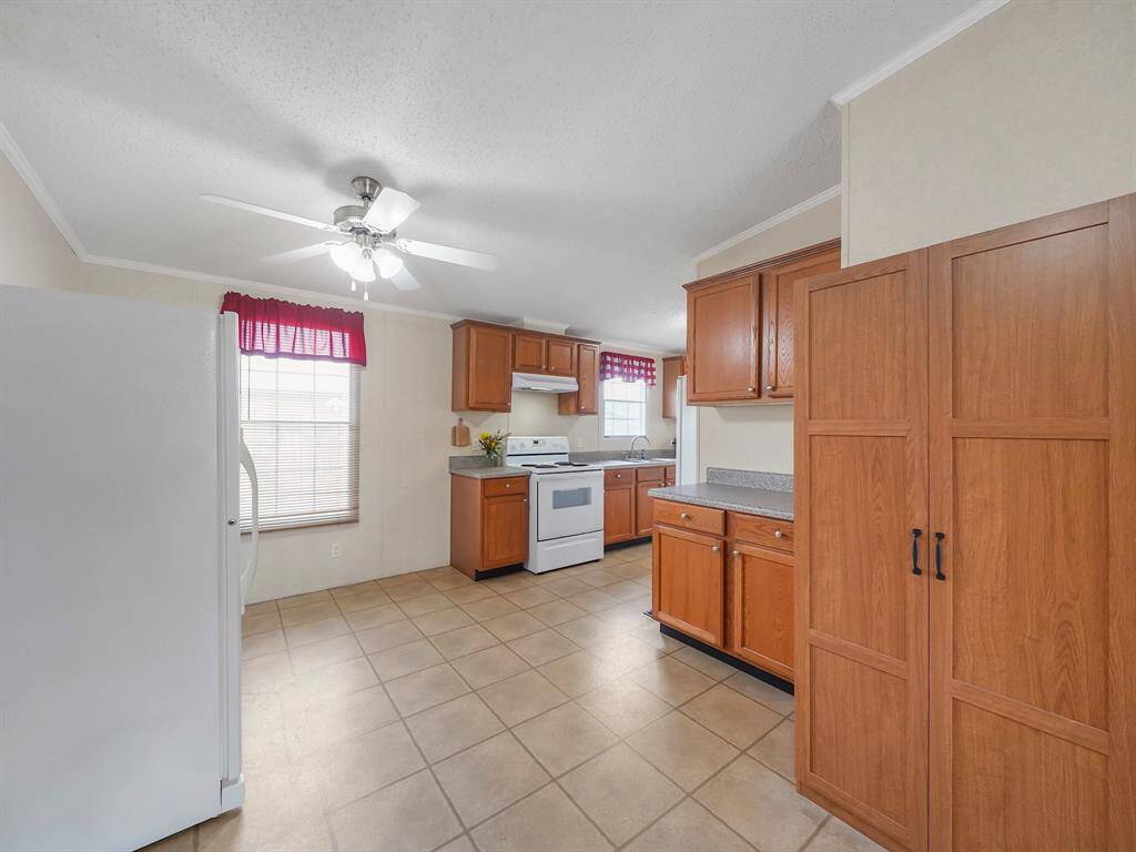Another view of the dining room, keep in mind the fridge to the left is an extra and is not the main area where the fridge actually goes.