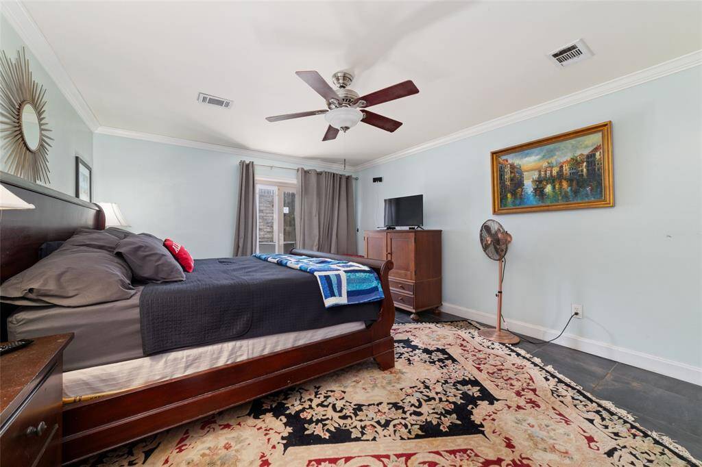 Primary with massive walk in closet (not shown) bedroom with warm wood tones and plenty of room for a king-sized bed. This space is peaceful and ideal for guests or family.