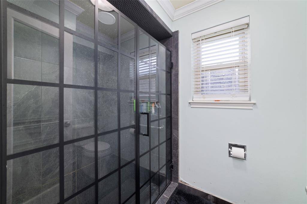 Oversized walk-in shower with glass block detail and built-in seating. A spa-like upgrade for your everyday routine.