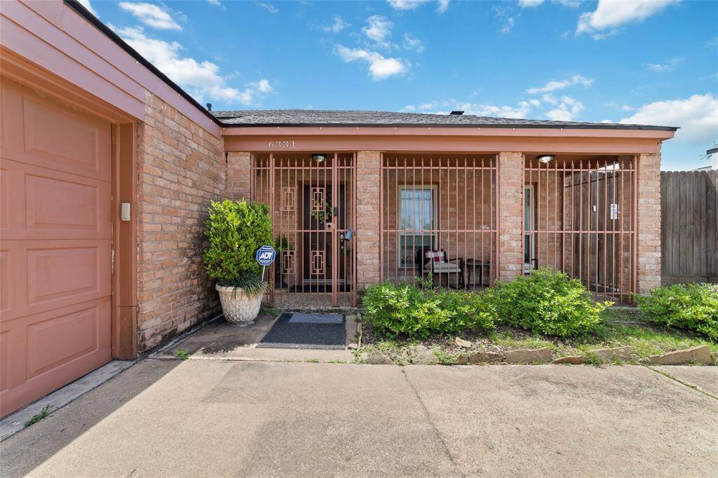 Inviting front entry with clean lines and modern brickwork. Mature landscaping adds a warm, welcoming feel as you arrive home.