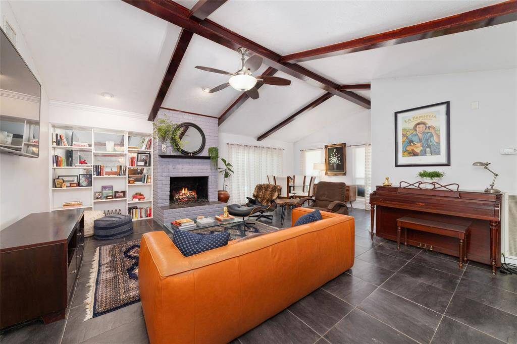 Spacious living area with soaring vaulted ceilings and exposed beams. The layout is open yet cozy, perfect for entertaining or quiet evenings at home.