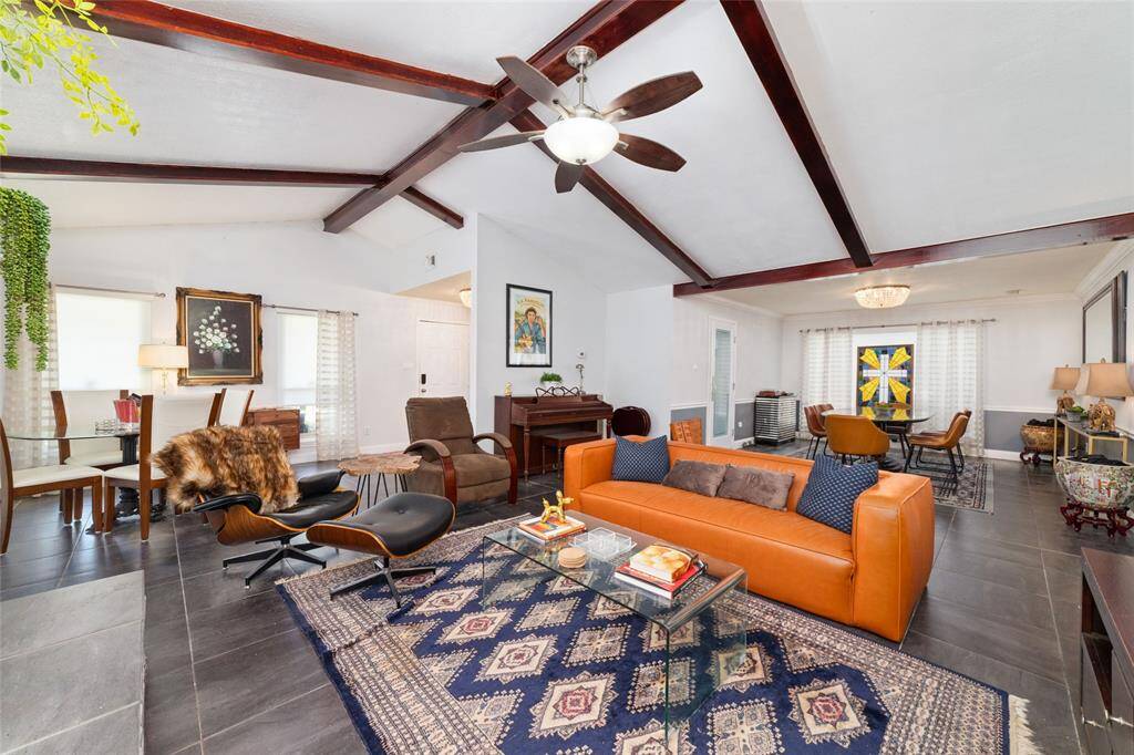 The living area opens seamlessly to the main living and dining spaces. The vaulted ceilings add architectural interest and depth throughout.