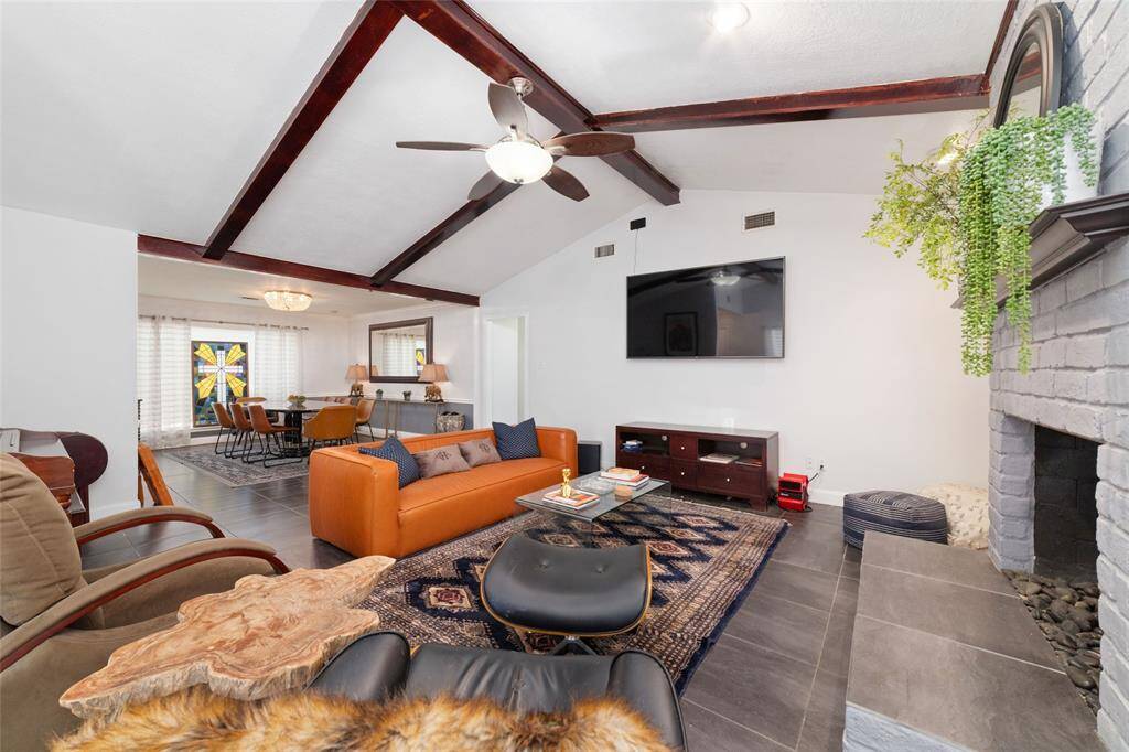 Another angle of the open-concept living showcasing wood beams and built-ins. This room flows beautifully for everyday living or hosting guests.