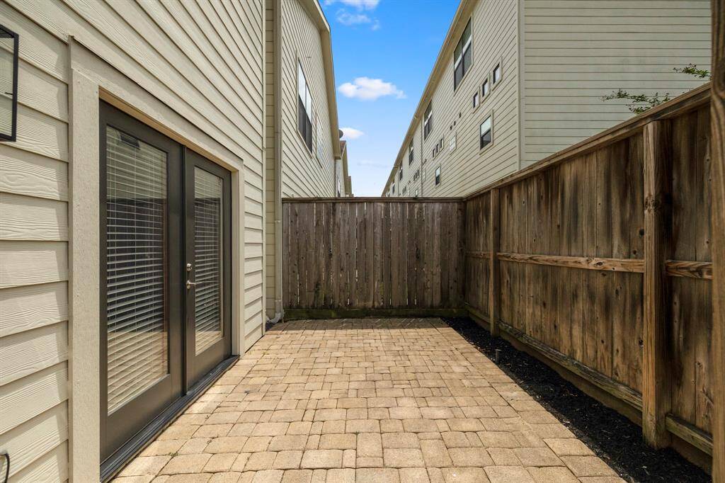 Low maintenance backyard with pavers throughout.