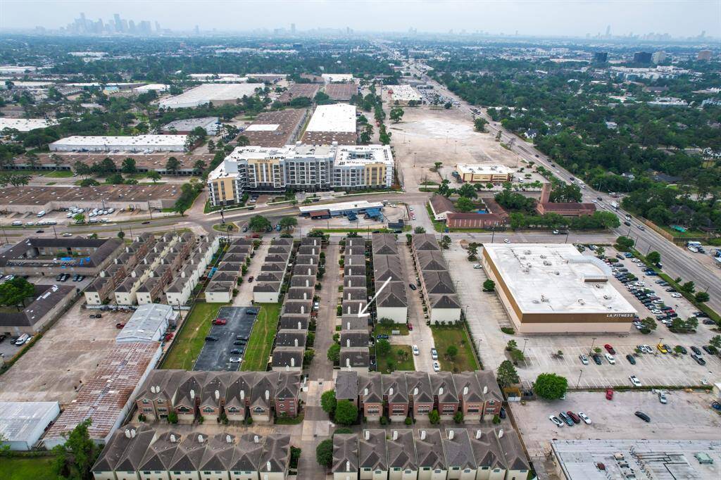 A bird’s eye view of this home looking south in proximity to I-10 in the background and downtown to the left.