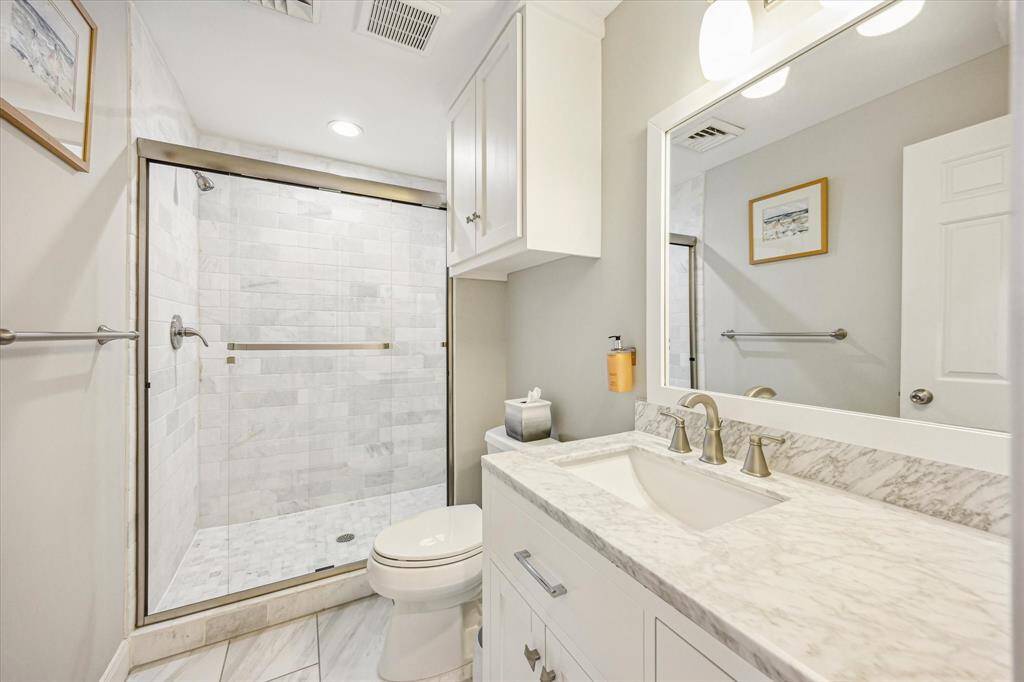 The secondary bath is spacious and thoughtfully designed, offering comfort and functionality for guests or family.