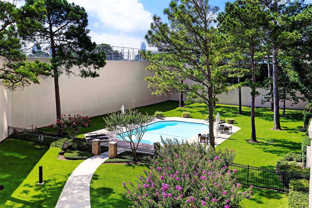 Escape the summer sun in the serene pool area, surrounded by lush gardens that offer a peaceful retreat from the city.