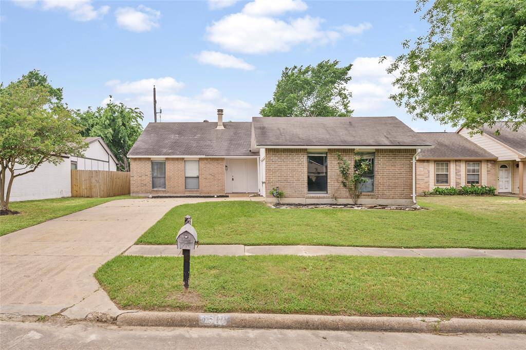 Charming one-story brick home with a well-maintained front yard, a spacious driveway, and a cozy porch. Ideal for a comfortable and inviting living experience.