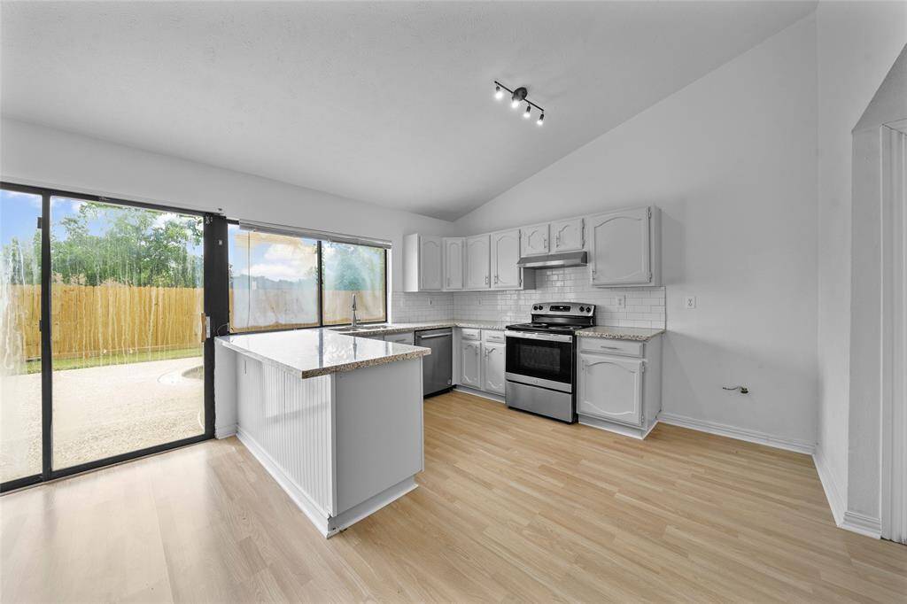 Kitchen with abundant counter space and storage, breakfast bar