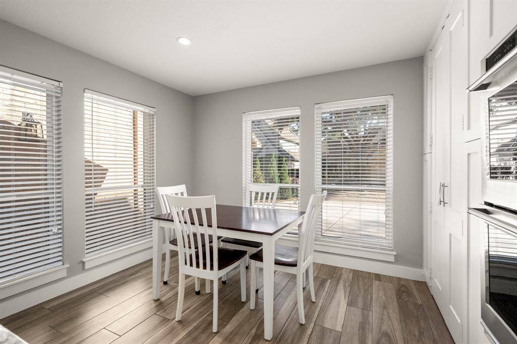 The kitchen is long enough to cover the entire length of the main floor with windows overlooking the front yard. The rear of the kitchen has sliding doors that lead to a patio.