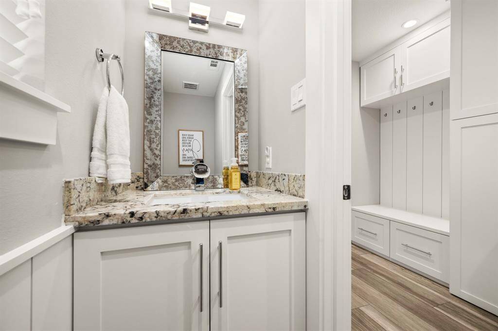 Laundry room offers a built-in drop zone for coats, bags, and shoes.