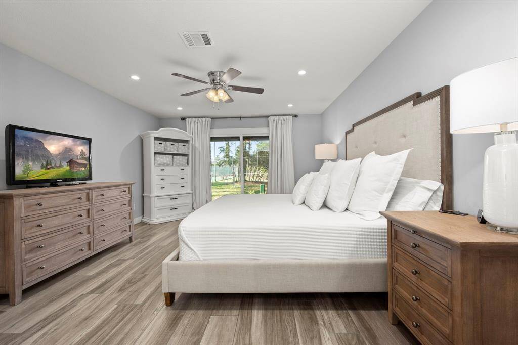 Primary bedroom is spacious and drenched in neutral tones.