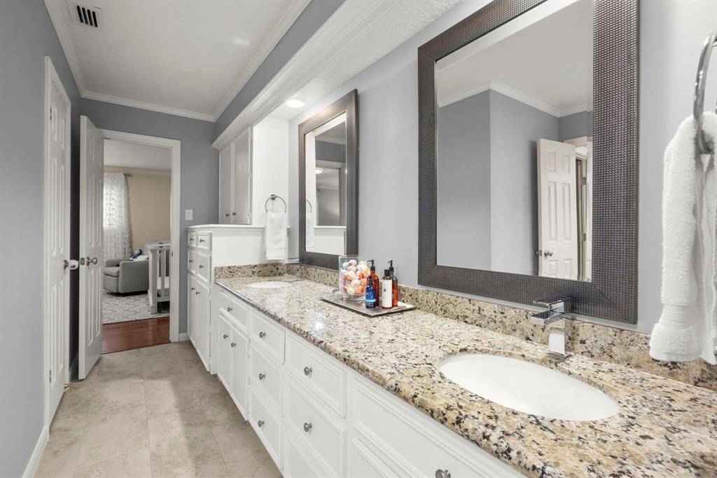 Upstairs hall bath has separate vanity area, granite counters, and private area for commode and shower/tub.