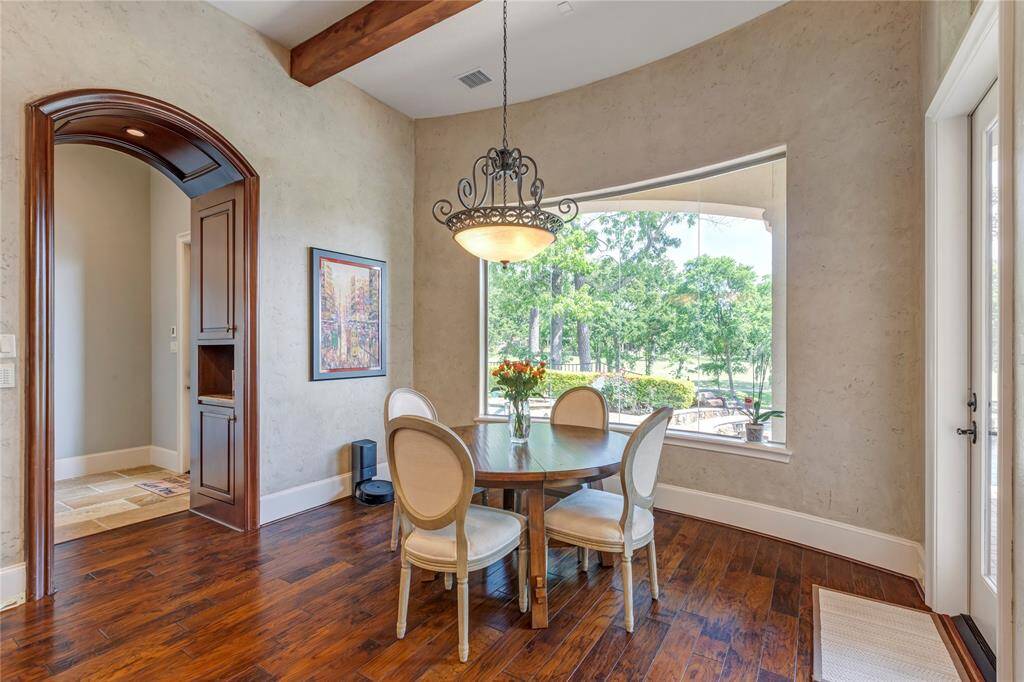 Breakfast area with views of back yard, golf course, and Lake Conroe.