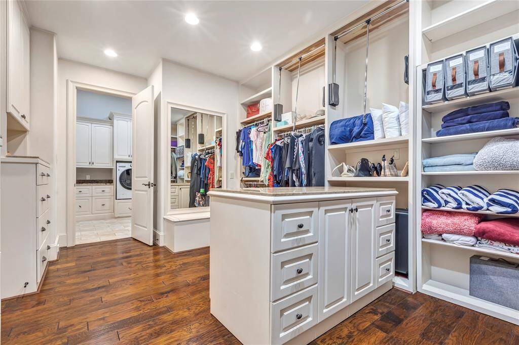 Primary closet with built-ins and the center island moves.  Pull downs for additional clothes storage.