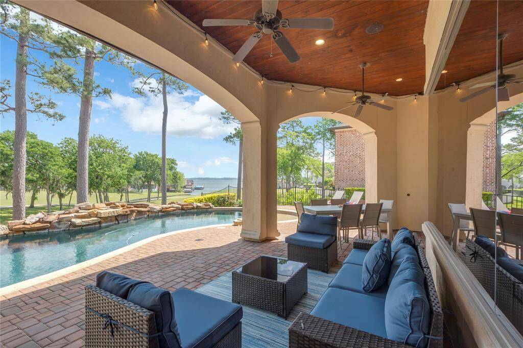 Saltwater pool with outdoor lighting and screens that come down.  The wooden ceiling has ceiling fans and plenty of entertaining areas.  Look at those views.  Awesome.