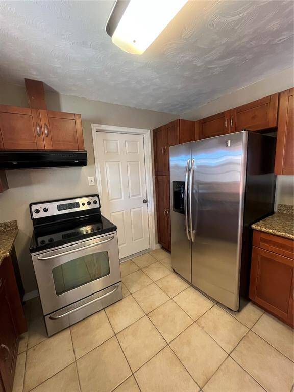 Close up of Stove/Refrigerator and cabinets.