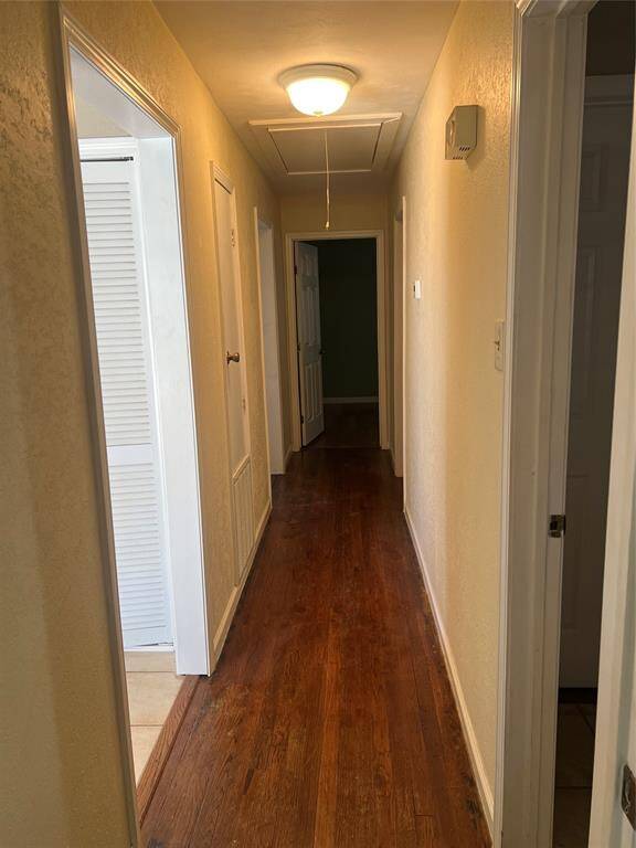 Hallway has wood floors.
