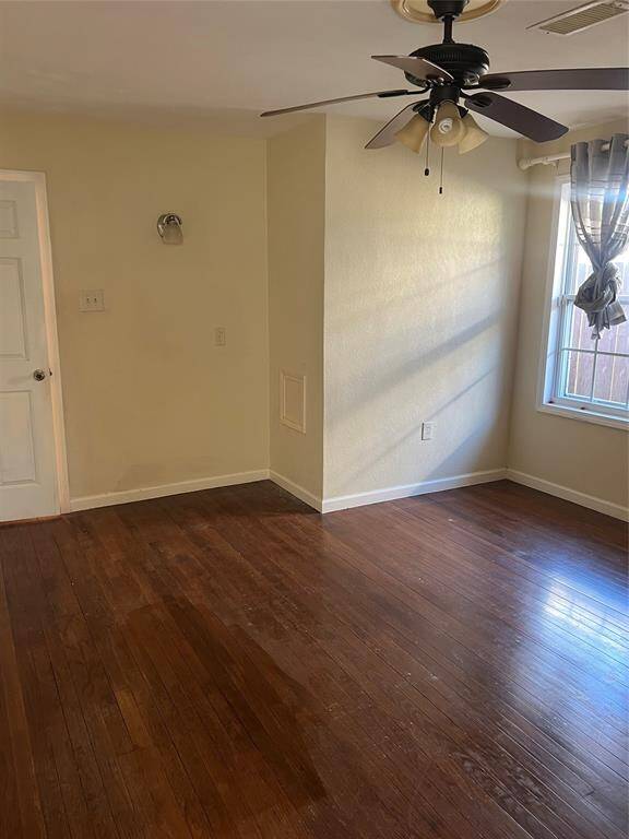 Primary bedroom. Wood floors with fan and natural light.