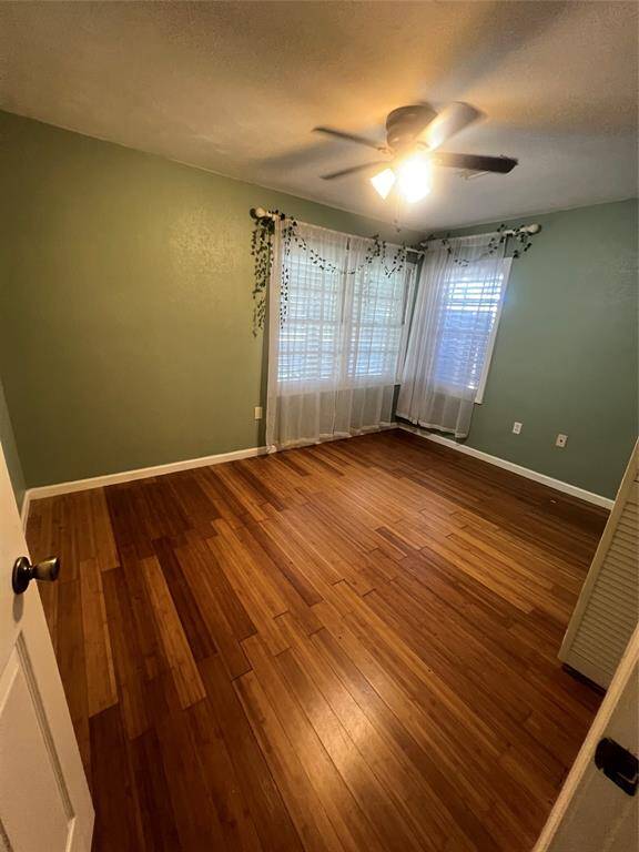 2nd bedroom with gorgeous floors, fan and plenty of natural light.