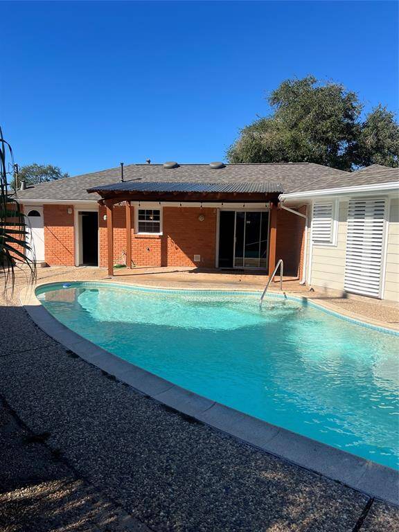 Backyard with pool/patio. Two doors lead to Garage & 3rd bath with Shower and wet area.