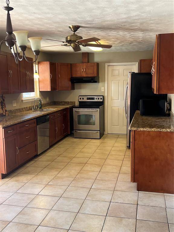 Kitchen is bright, with plenty of cabinets and granite countertops. Stainless steel oven, dishwasher and refrigerator. Microwave stays.