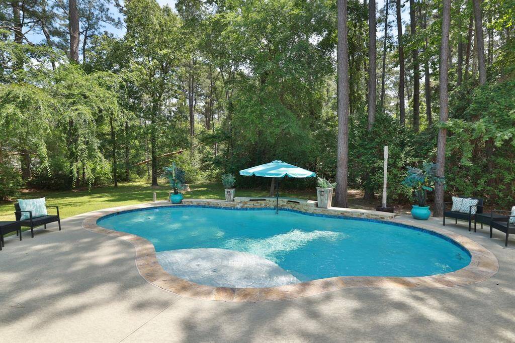 Welcome Home. Escape to your own private retreat with this stunning resort-style pool set in a serene woodland backdrop. Surrounded by lush trees and natural landscaping, the pool area offers a perfect blend of luxury and tranquility. Whether you're lounging on the sun deck, taking a dip in the crystal-clear waters, or entertaining guests, every moment here feels like a getaway. This one-of-a-kind outdoor sanctuary brings the feel of a five-star resort right to your backyard.